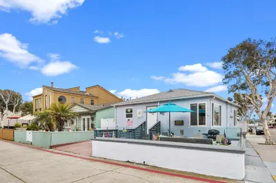 a house with an umbrella on a street at Beach-2-Bay 2br - Beach - AC - Patio in San Diego