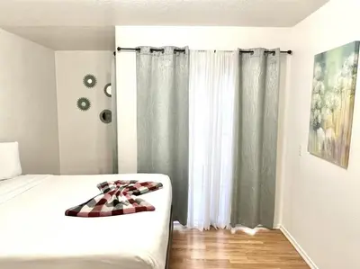 a bedroom with a bed with a checkered blanket on it at Charming 2nd Ave Lofts in Downtown San Diego with Parking in San Diego