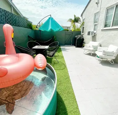 a backyard with a water slide and a tent at Crown Point Home w/ Cowboy Pool 2 Blocks to Bay in San Diego