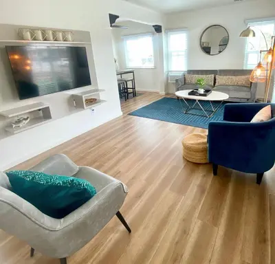 a living room with a couch and a tv at Crown Point Home w/ Cowboy Pool 2 Blocks to Bay in San Diego