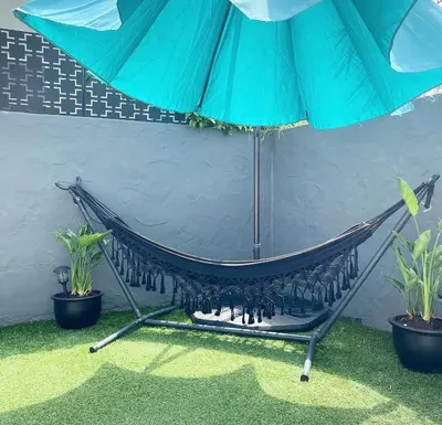 a hammock with a blue umbrella and two plants at Crown Point Home w/ Cowboy Pool 2 Blocks to Bay in San Diego