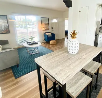 a living room with a table and a couch at Crown Point Home w/ Cowboy Pool 2 Blocks to Bay in San Diego