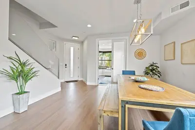 a dining room with a table and blue chairs at Pacific Beach Paradise by Cardo -Spacious Retreat in San Diego