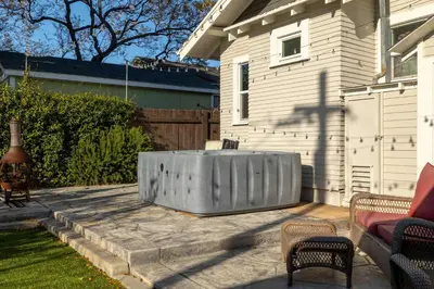 a metal tub sitting on a patio next to a house at South Park Charmer - Close to Zoo - Backyard Oasis in San Diego
