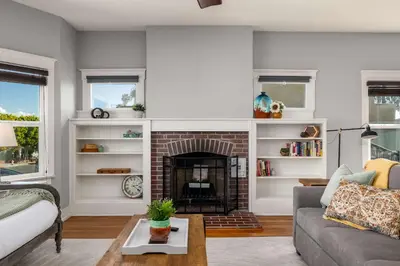 a living room with a fireplace and a couch at South Park Charmer - Close to Zoo - Backyard Oasis in San Diego