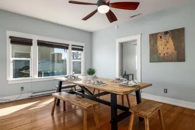 a dining room with a table and a ceiling fan at South Park Charmer - Close to Zoo - Backyard Oasis in San Diego