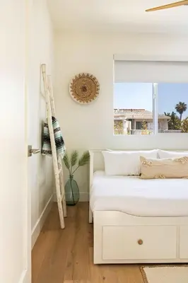a white bedroom with two beds and a ladder at Contemporary Indoor Outdoor Living Walk to Beach in Encinitas