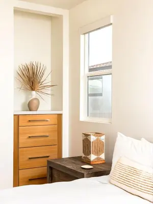 a bedroom with a bed with a dresser and a window at Contemporary Indoor Outdoor Living Walk to Beach in Encinitas
