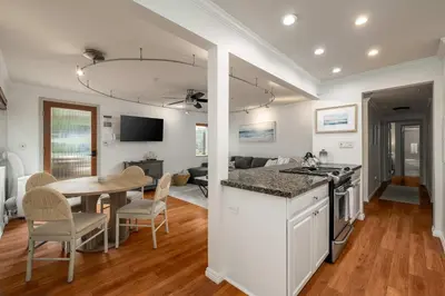 a kitchen and living room with a table and a dining room at REDECORATED - Seaside Dream - Jacuzzi - Patio in San Diego