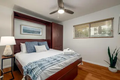 a bedroom with a bed and a ceiling fan at REDECORATED - Seaside Dream - Jacuzzi - Patio in San Diego