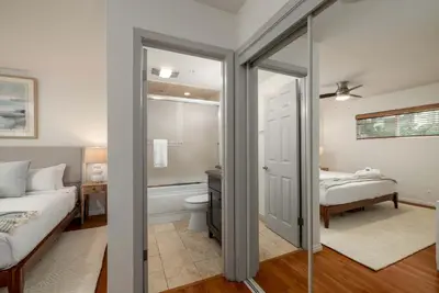 a bedroom with a bed and a bathroom with a toilet at REDECORATED - Seaside Dream - Jacuzzi - Patio in San Diego
