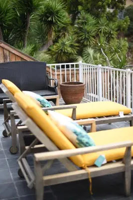 a couple of surfboards sitting on top of a chair at Mile to Beach! Private, Family & Pet Friendly Oasis! Pool Table & Hot tub! in Oceanside