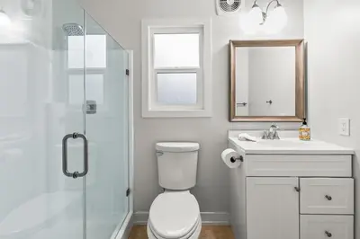 a bathroom with a toilet and a sink and a shower at Mile to Beach! Private, Family & Pet Friendly Oasis! Pool Table & Hot tub! in Oceanside