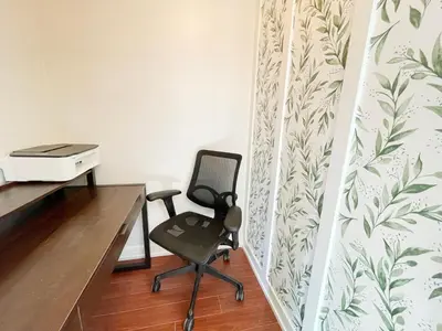 a desk and a chair in a room with a wall at Mile to Beach! Private, Family & Pet Friendly Oasis! Pool Table & Hot tub! in Oceanside