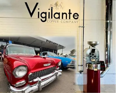 an old red car parked in front of a coffee company at Mile to Beach! Private, Family & Pet Friendly Oasis! Pool Table & Hot tub! in Oceanside