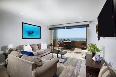 a living room with two couches and a large window at Water Front Spectacular Ocean View Large Balcony AC Pet Friendly in Oceanside