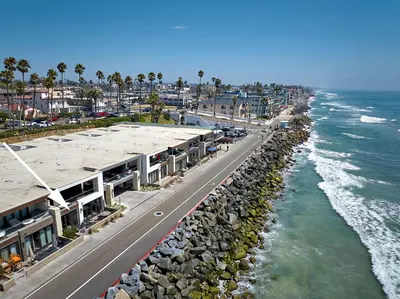 an aerial view of a beach with buildings and the ocean at Water Front Spectacular Ocean View Large Balcony AC Pet Friendly in Oceanside