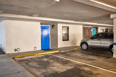 a car parked in a parking lot with a blue door at Water Front Spectacular Ocean View Large Balcony AC Pet Friendly in Oceanside