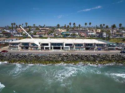 an aerial view of a building next to the water at Water Front Spectacular Ocean View Large Balcony AC Pet Friendly in Oceanside