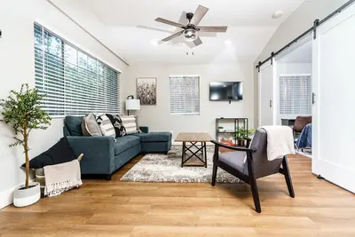 a living room with a blue couch and a ceiling fan at Entire 2 bedroom Pet Friendly Guest Cottage in Alpine