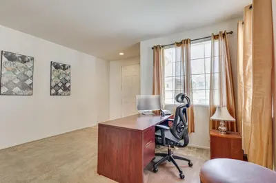 an office with a desk and a chair and a window at Large Menifee Home 1 Block to Neighborhood Park! in Menifee