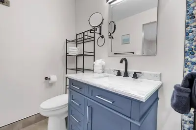 a bathroom with a blue sink and a toilet at Ultimate Oceanside Retreat | Tower 9 Across from the Beach in Oceanside