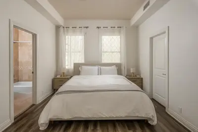 a white bedroom with a bed and a bath tub at Ocean View Del Mar Beach Home w Jacuzzi in San Diego