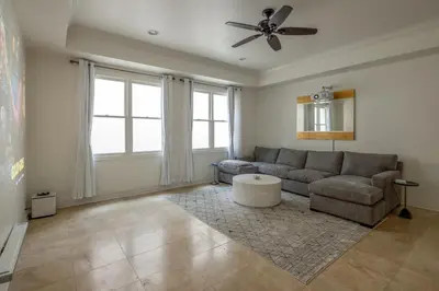 a living room with a couch and a ceiling fan at Ocean View Del Mar Beach Home w Jacuzzi in San Diego