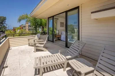 a patio with three chairs and a table on a house at Ocean View Del Mar Beach Home w Jacuzzi in San Diego