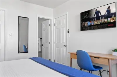 a bedroom with a desk and a blue chair at Beachside Bliss 2BR with Fast WiFi in San Diego