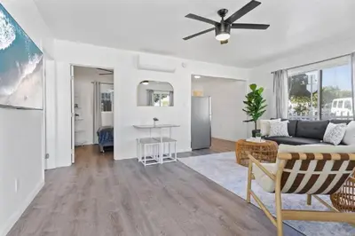 a living room with a couch and a ceiling fan at Beachside Bliss 2BR with Fast WiFi in San Diego