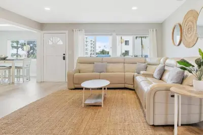 a living room with a couch and a table at Spacious Beach House! Walk to Beach and Pier in Oceanside