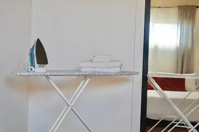 a shelf with towels and a computer on it in a room at San Diegos Best Zoo, SeaWorld and Downtown Nearby in San Diego