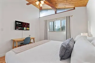 a bedroom with a bed and a desk and a window at Remodeled Boho 2 Bed Near Zoo and Downtown in San Diego
