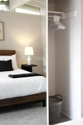 a bedroom with a bed and a mirror at Relax and Play Pool, Hot Tub and Sleeps 16 in San Diego