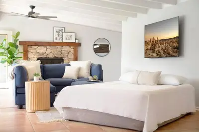 a bedroom with a bed and a couch at Relax and Play Pool, Hot Tub and Sleeps 16 in San Diego