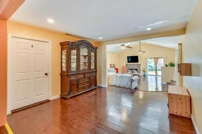 a large living room with a large wooden cabinet at Spring Valley Family Home 13 Mi to San Diego! in Spring Valley
