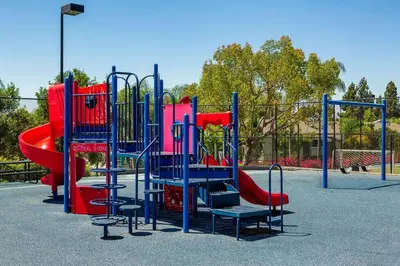 a playground with a red and blue play equipment at Shabby Chic Oceanside King & 2 Queen bed Pool GYM in Oceanside