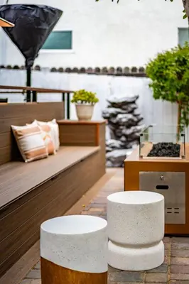 two white stools sitting in the middle of a patio at Pacific Beach Bungalow Just Steps to Beach in San Diego