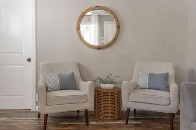 two chairs and a mirror in a living room at Pacific Beach Bungalow Just Steps to Beach in San Diego