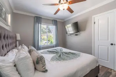 a bedroom with a bed with a ceiling fan at Pacific Beach Bungalow Just Steps to Beach in San Diego