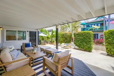 an outdoor patio with couches and tables and chairs at Avalon Beach 2 in San Diego