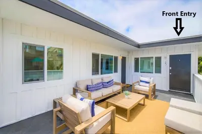 a porch with a couch and chairs and a table at Avalon Beach 3 in San Diego