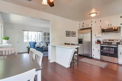 a kitchen and living room with a table and chairs at Avalon Beach 3 in San Diego