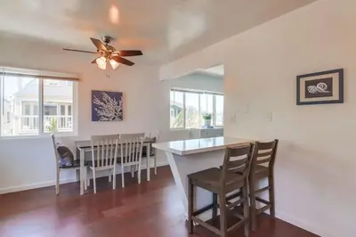 a kitchen and dining room with a table and chairs at Avalon Beach 3 in San Diego