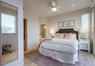 a bedroom with a large bed and a ceiling fan at Aloha Breeze 2 in San Diego