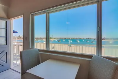 a table and chairs in a room with a large window at Bayside 4 in San Diego