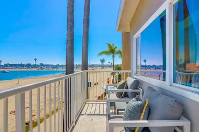 a balcony with a couch and a view of the beach at Bayside 4 in San Diego