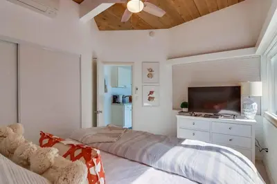a bedroom with a bed and a flat screen tv at Bayside 5 in San Diego