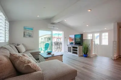 a living room with a couch and a tv and a table at Bayside Cove 2 in San Diego